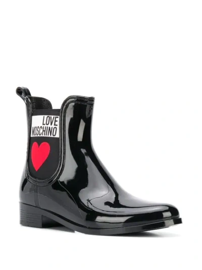 Shop Love Moschino Heart Print Rain Boots In Black