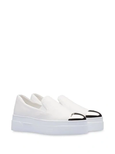 Shop Miu Miu Metal Cap Slip-on Sneakers In White