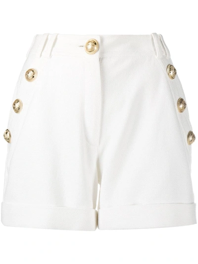 Shop Balmain Embossed Buttons Shorts In White