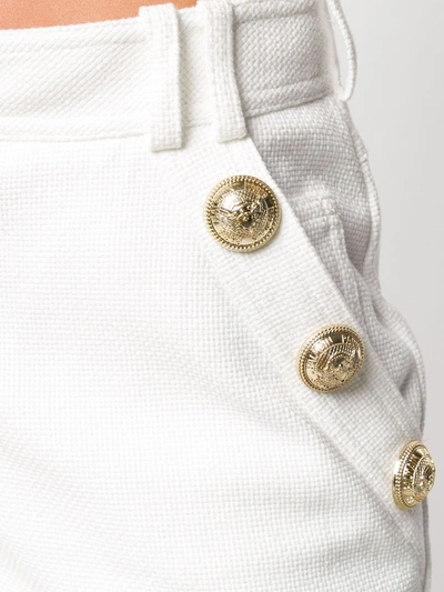 Shop Balmain Embossed Buttons Shorts In White