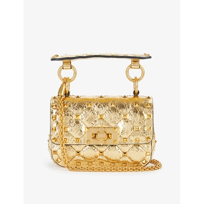 Shop Valentino Rockstud Spike Micro Quilted Metallic Leather Cross-body Bag In Antique Brass