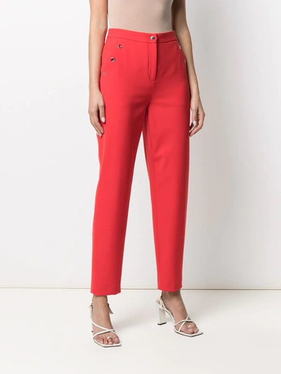 Shop Moschino High-waisted Eyelet-detail Trousers In Red