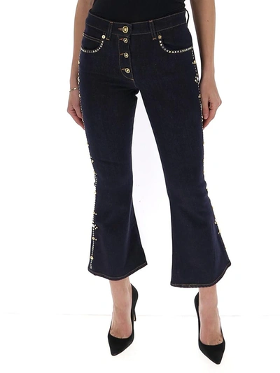 Shop Versace Embellished Cropped Flared Jeans In Blue