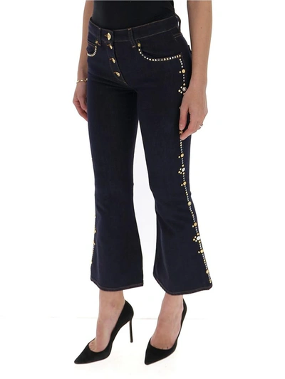 Shop Versace Embellished Cropped Flared Jeans In Blue