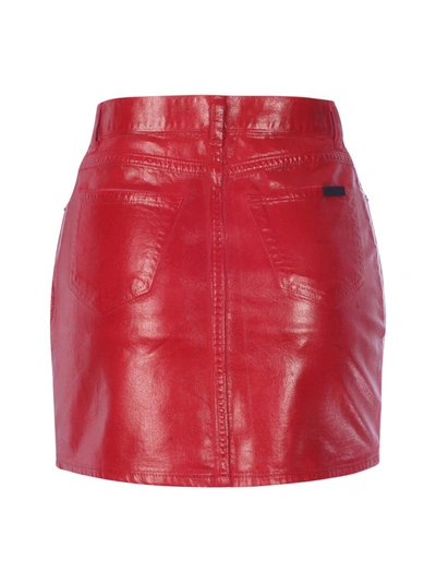 Shop Saint Laurent Treated Denim Mini Skirt In Red