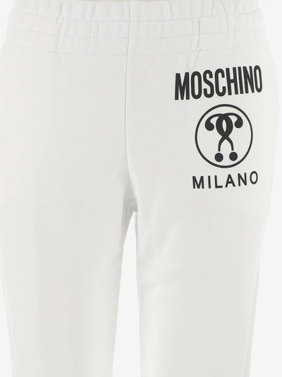 Shop Moschino Milano Logo Print Track Pants In White