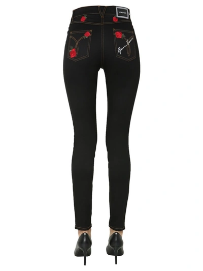 Shop Versace Rose Embroidered Skinny Leg Jeans In Black