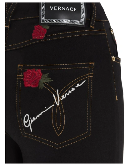 Shop Versace Rose Embroidered Skinny Leg Jeans In Black