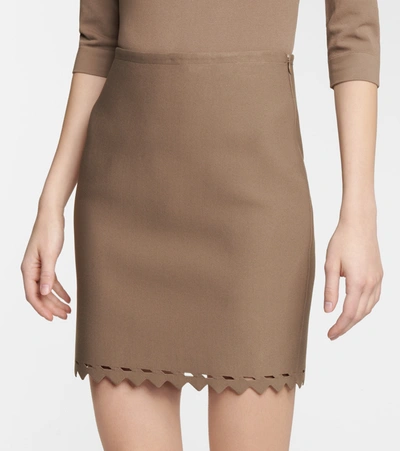 Shop Alaïa Laser-cut Stretch-knit Miniskirt In Beige