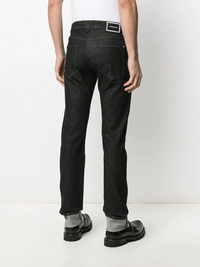 Shop Versace Logo Patch Straight-leg Jeans In Black