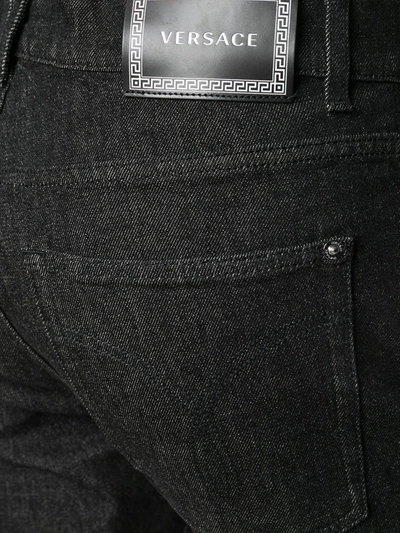 Shop Versace Logo Patch Straight-leg Jeans In Black