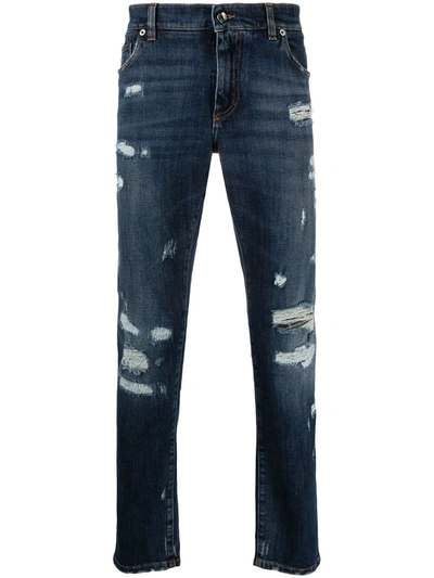 Shop Dolce & Gabbana Embossed Logo Ripped Slim-fit Jeans In Blue