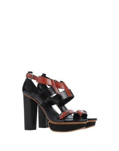 Shop Tod's Sandals In Black