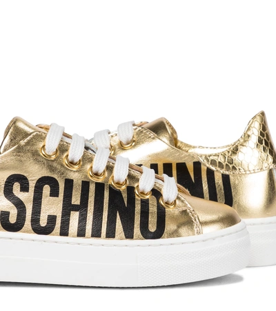 Shop Moschino Metallic Leather Sneakers In Gold