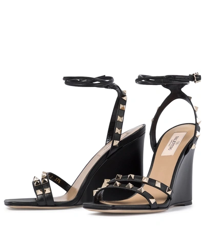 Shop Valentino Rockstud Leather Wedge Sandals In Black