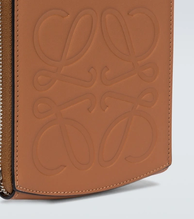 Shop Loewe Anagram Embossed Leather Pouch In Brown