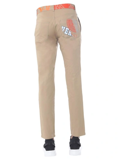 Shop Versace "compilation" Trousers In Beige