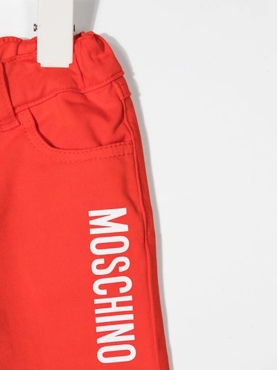 Shop Moschino Logo-print Cotton Jeans In Red