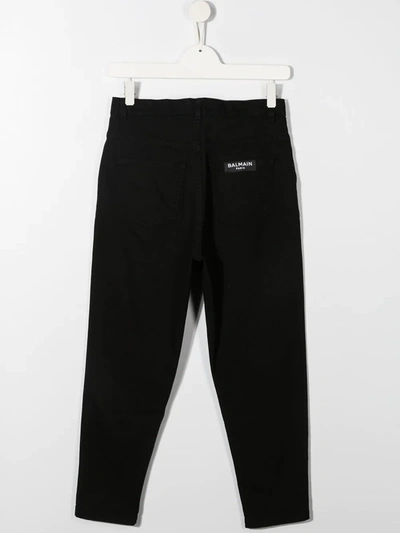 Shop Balmain Button-embellished Tapered Trousers In Black