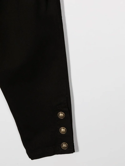Shop Balmain Buttoned-embellished Tapered Trousers In Black