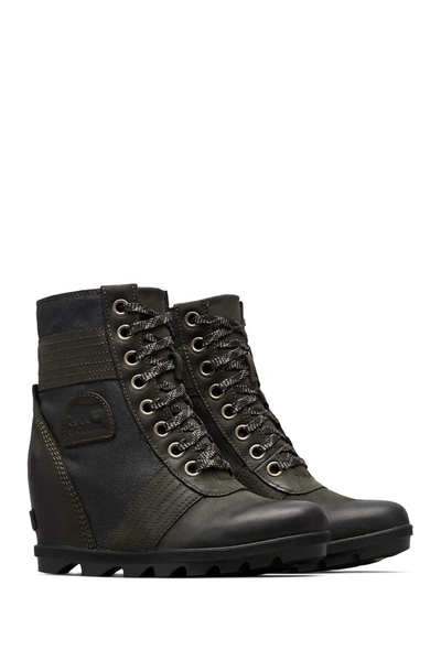 Shop Sorel Lexie Waterproof Leather Wedge Boot In Black