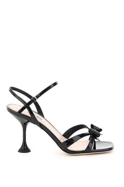 Shop Miu Miu Patent Leather Bow Sandals In Nero (black)
