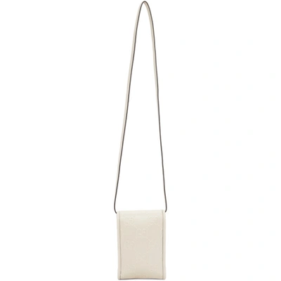 Shop Gucci Off-white Mini Gg Embossed Pouch In 9022 Mystic