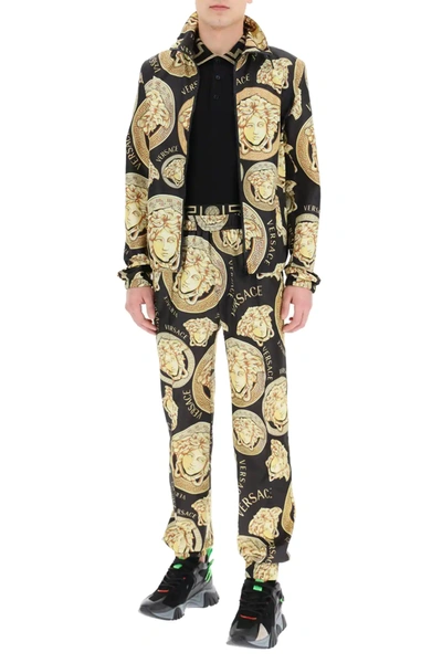 Shop Versace Amplified Medusa Print Trousers In Black,gold