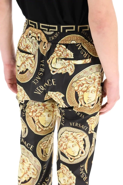 Shop Versace Amplified Medusa Print Trousers In Black,gold