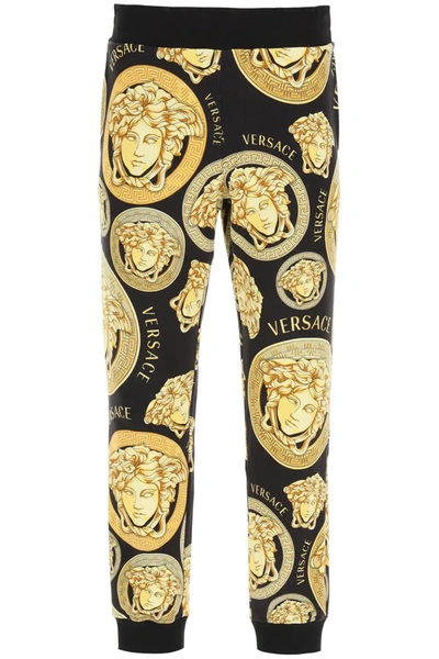 Shop Versace Amplified Medusa Print Jogging Trousers In Black,gold