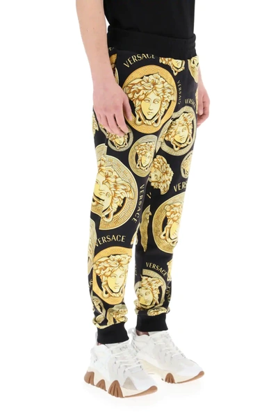Shop Versace Amplified Medusa Print Jogging Trousers In Black,gold