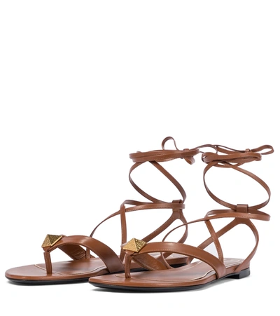 Shop Valentino Roman Stud Leather Thong Sandals In Brown