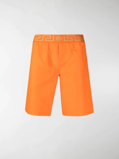 Shop Versace Grecca Waistband Swimming Shorts In Orange