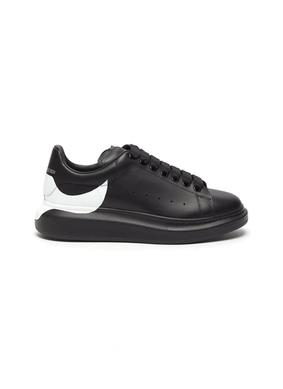 Shop Alexander Mcqueen 'oversized Sneakers' In Leather With Displaced Heel Tab Print In Black,white