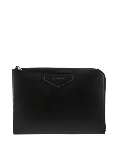 Shop Givenchy Embossed Logo Clutch In Black