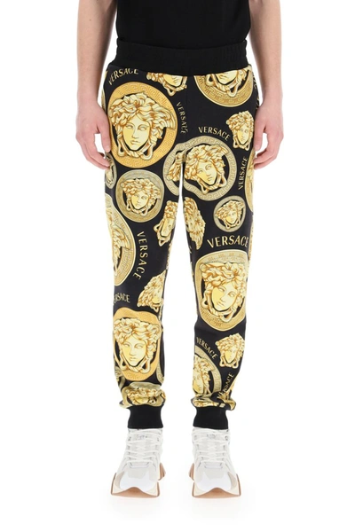 Shop Versace Amplified Medusa Print Jogging Trousers In Nero Oro