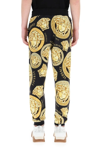 Shop Versace Amplified Medusa Print Jogging Trousers In Nero Oro