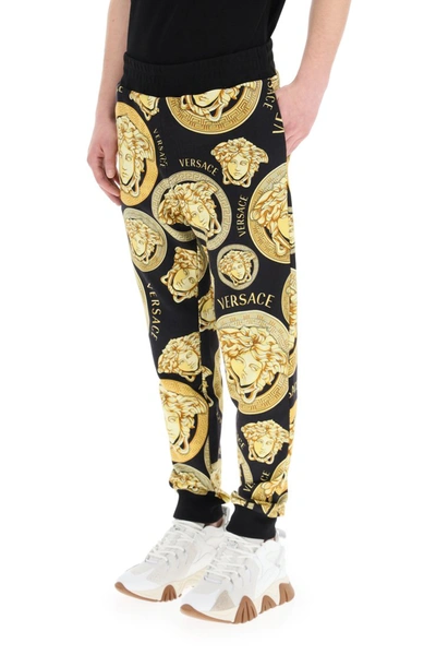 Shop Versace Amplified Medusa Print Jogging Trousers In Nero Oro