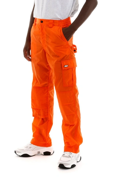 Shop Msgm Nylon Cargo Trousers In Arancio