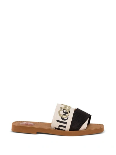 Shop Chloé Woody Bicolor Sandals With Logo In White/black