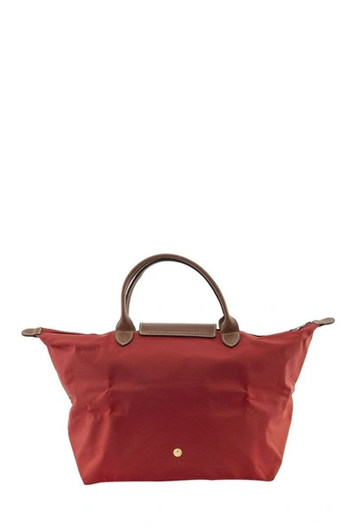 Shop Longchamp Le Pliage - Top Handle M In Red