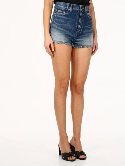 Shop Saint Laurent Raw-edge Denim Shorts In Blue