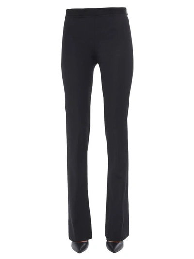 Shop Versace Flared Trousers In Black