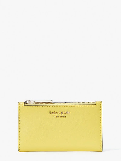 Shop Kate Spade Spencer Small Slim Bifold Wallet In Yellow Sesame