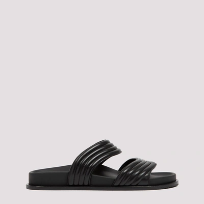 Shop Alaïa Flat Mules In Black