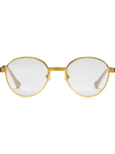 Shop Gucci Round Frame Sunglasses In Gold