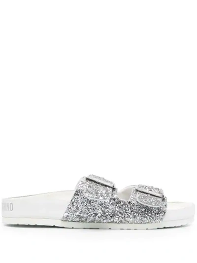 Shop Love Moschino Glitter Buckled Slides In Grey