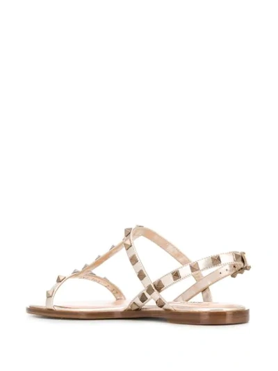 Shop Valentino Rockstud Flat Sandals In Gold