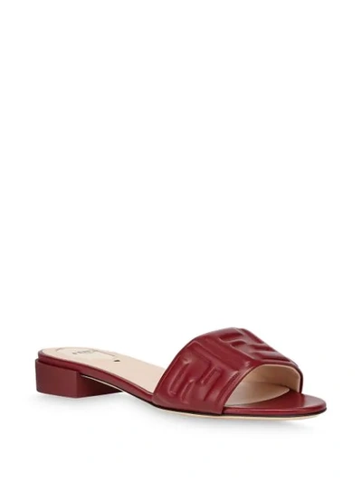 Shop Fendi Embossed Logo Low Heel Slide Sandals In Brown