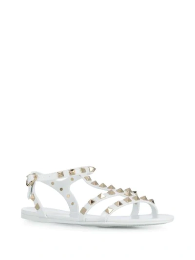 Shop Valentino Rockstud Flat Sandals In White